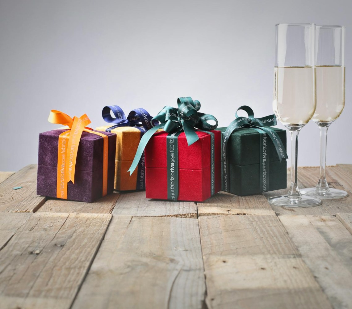 five assorted gift boxes and two flute glasses